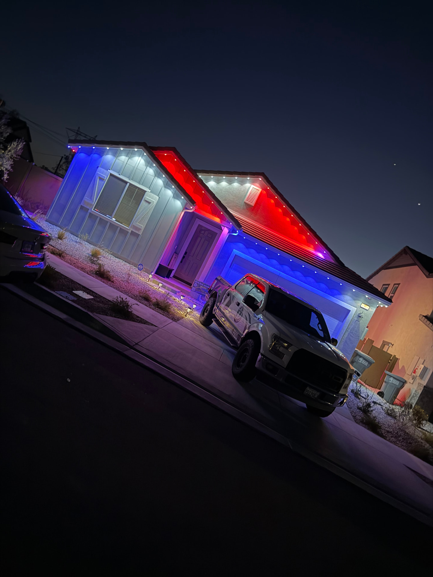 Red, white and blue patriotic permanent lighting on a single-story home