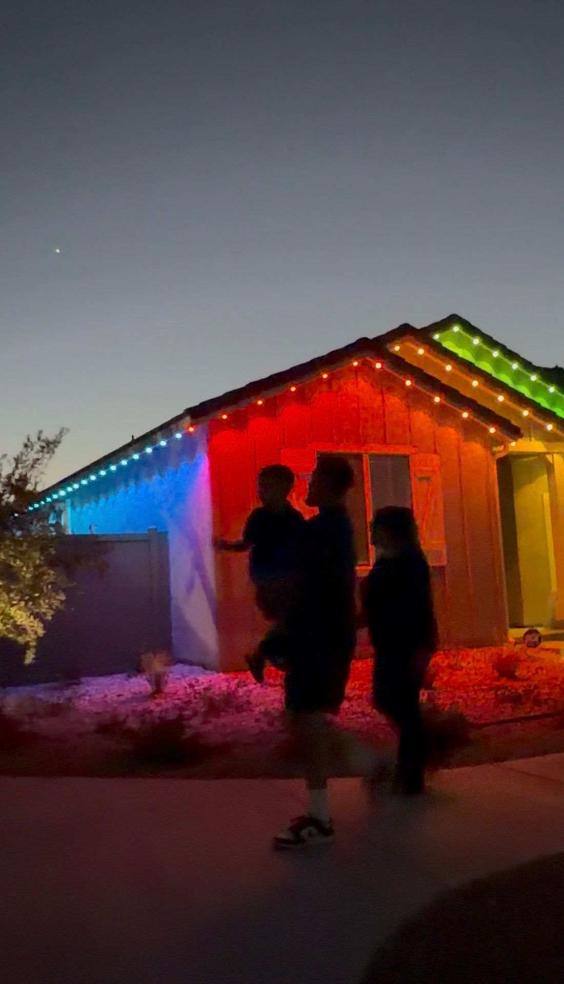 Red, blue and green holiday colors on a permanent LED installation at dusk